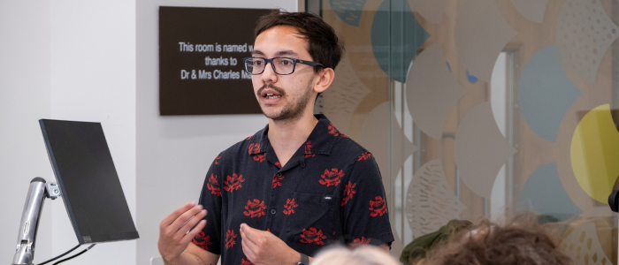 A student conducting a workshop in a meeting room