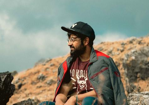 A photo of Tilak Tewari sitting on a rocky mountain