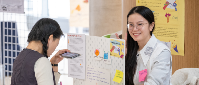 Two researchers interacting at a research exhibit display