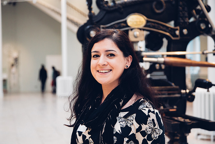 Researcher poses for picture in a museum