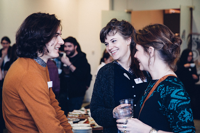 Three researchers chat at a SGSAh event
