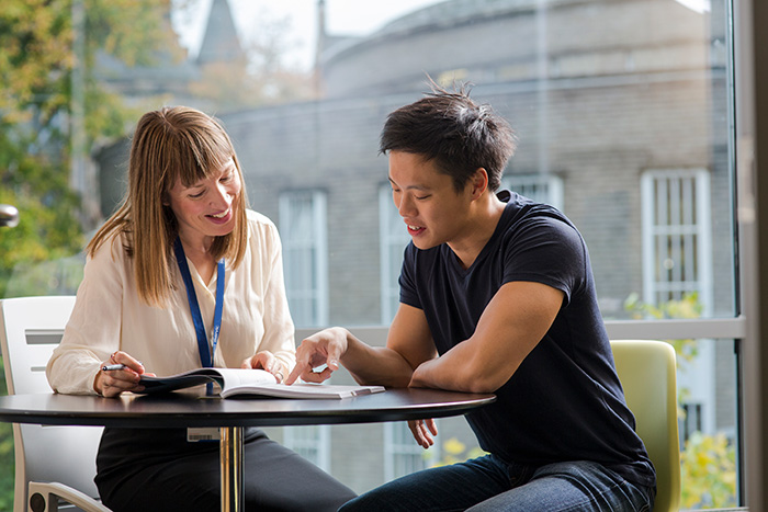 A staff member talks to a student