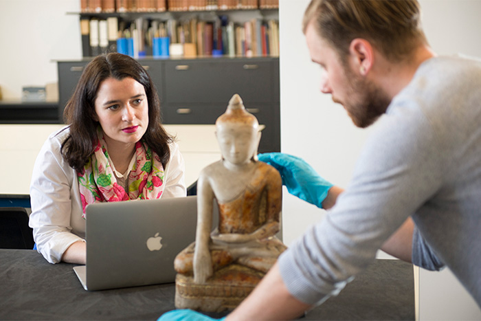Two researchers analyse an artefact