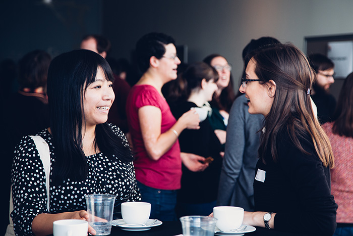 Two researchers chat at a SGSAH event
