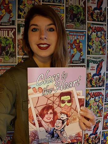 Megan Sinclair holds a copy of her comic 