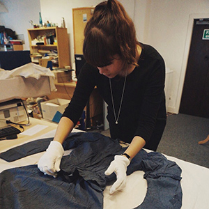 A student examining a costume at the Museum of Edinburgh costume gallery