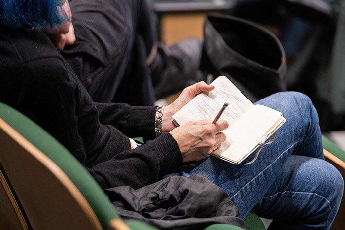 A student writing in their notebook